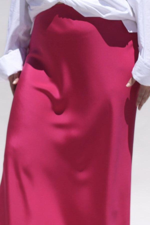 This Sapphire Pink silk slip skirt is cut on the bias for a fluid finish and falls elegantly to the ankle. Detail image.
