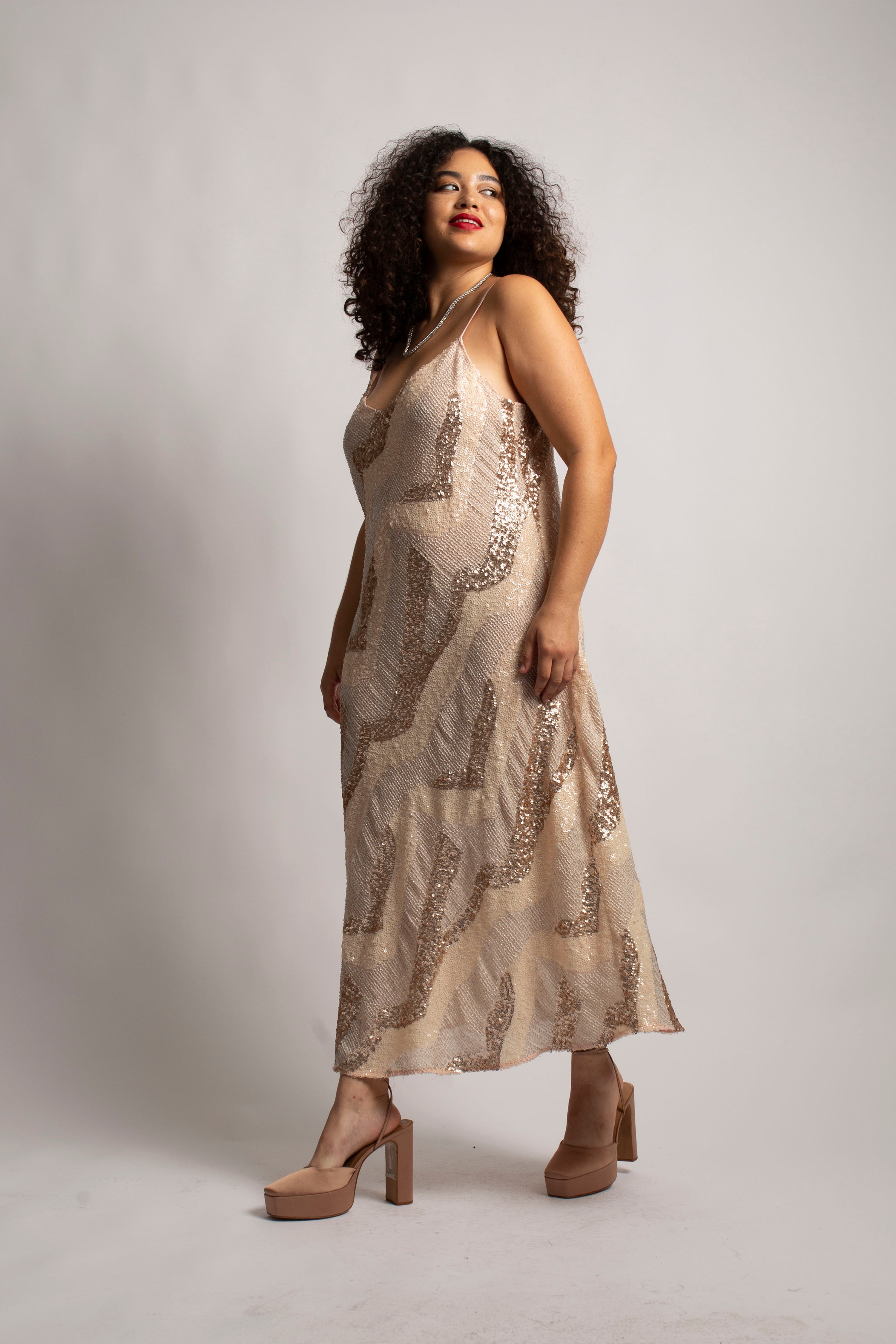 full body side view shot of model wearing beaded cabaret dress