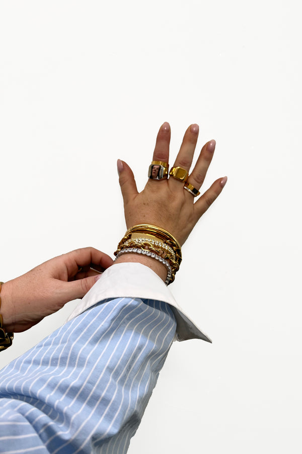 jewelry stacks on hand with bracelets and rings