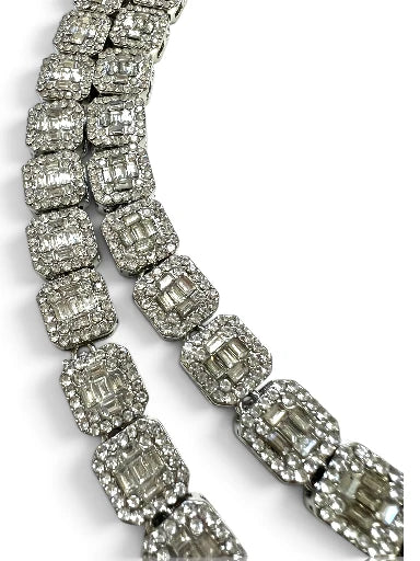 A close-up of a CZ encrusted necklace featuring rectangular baguette-cut CZ 
