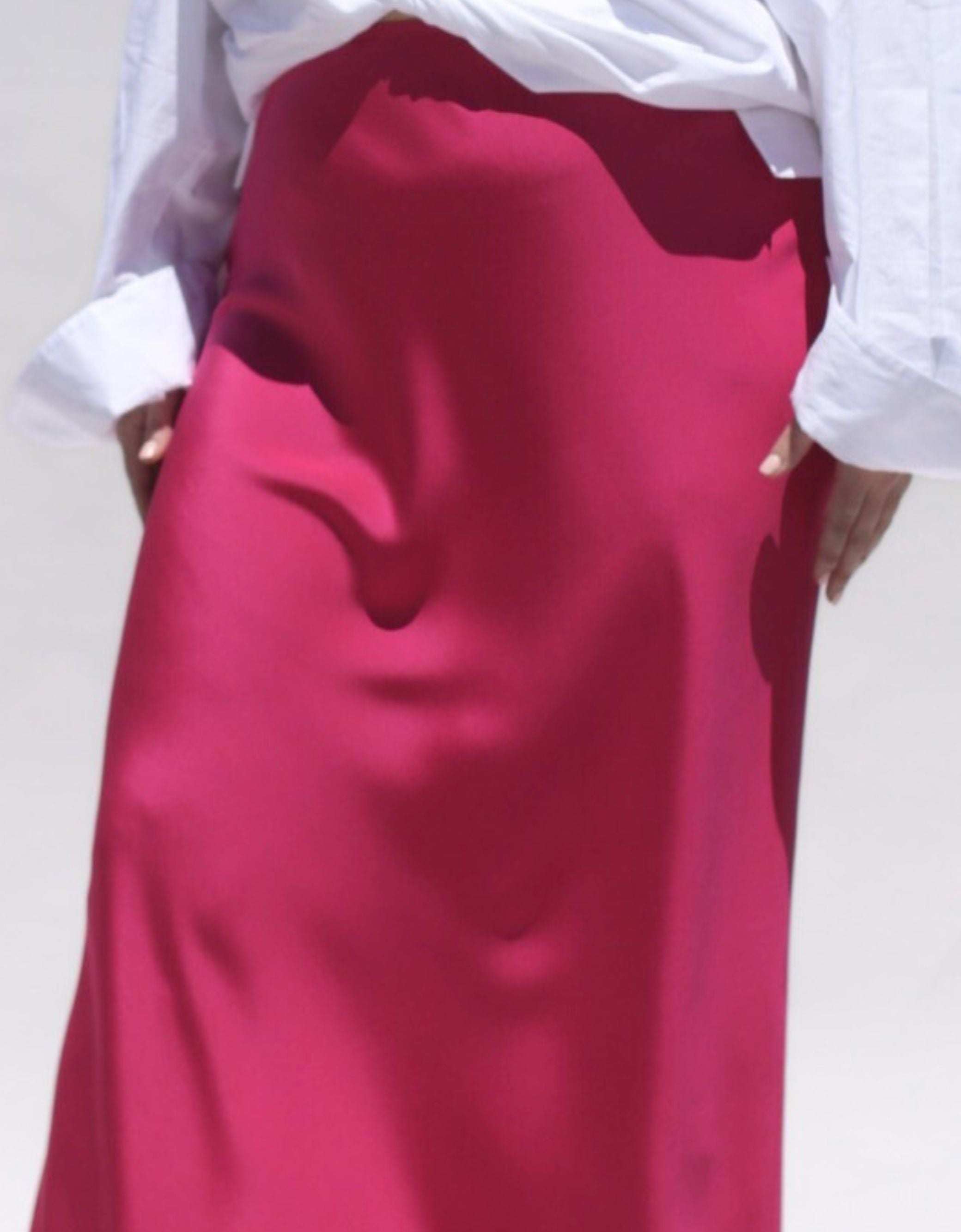 This Sapphire Pink silk slip skirt is cut on the bias for a fluid finish and falls elegantly to the ankle. Detail  image.