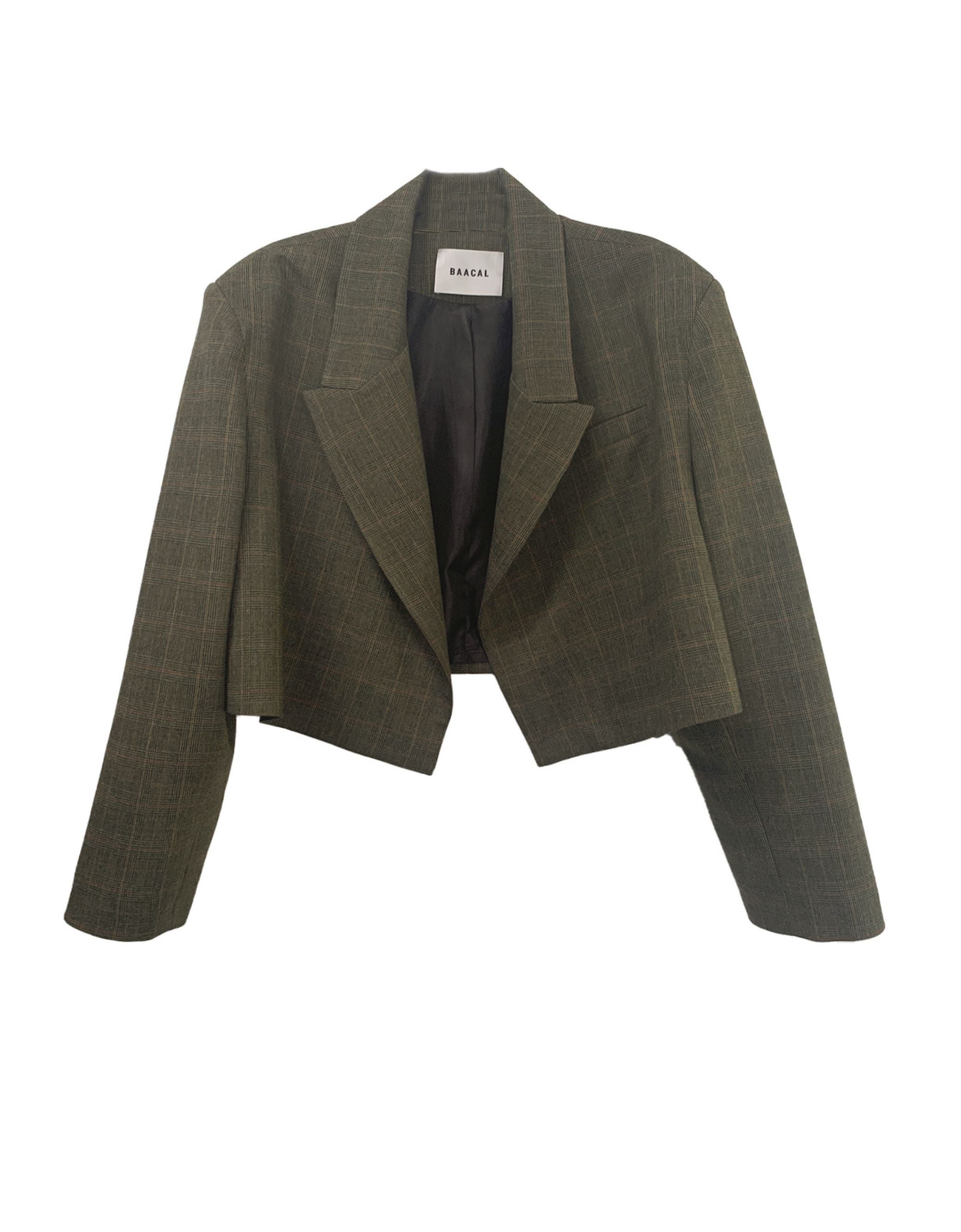 The Crop Blazer is offered here in a subtle Green Grey Prince of Wales plaid. The best Item to update your Fall wardrobe. Perfect to wear open or closed with inside hidden buttons. Made of a lightweight Wool blend, double-breasted with tailored shoulders and buttoned cuffs. A go-anywhere, anyway favorite you will reach for from Fall through Spring. This blazer was made using upcycled material and trims made and tailored in Los Angeles. Good for you and good for the planet.