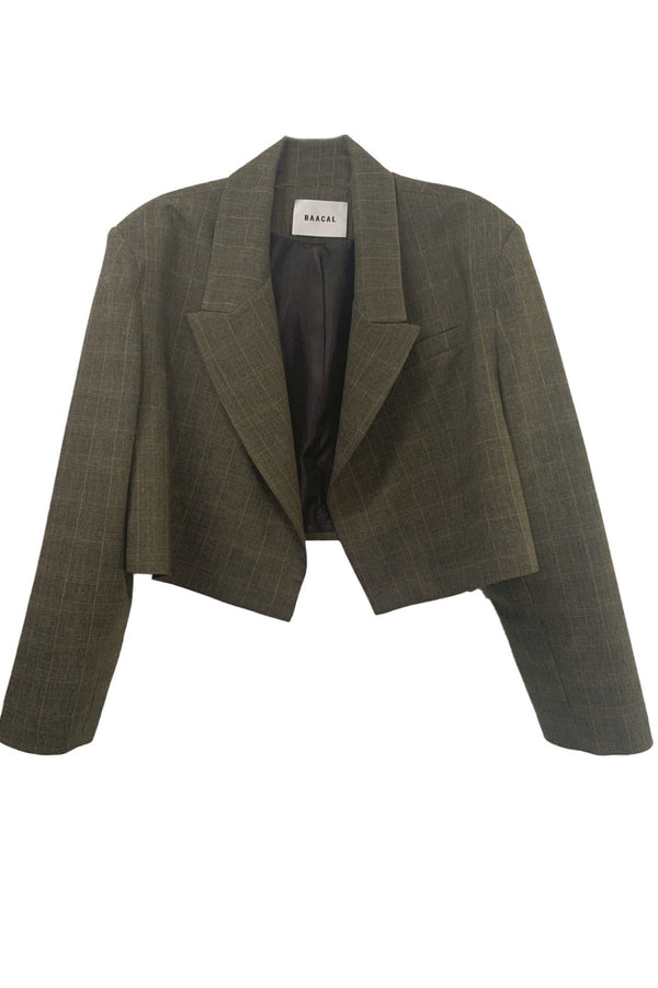The Crop Blazer is offered here in a subtle Green Grey Prince of Wales plaid. The best Item to update your Fall wardrobe. Perfect to wear open or closed with inside hidden buttons. Made of a lightweight Wool blend, double-breasted with tailored shoulders and buttoned cuffs. A go-anywhere, anyway favorite you will reach for from Fall through Spring. This blazer was made using upcycled material and trims made and tailored in Los Angeles. Good for you and good for the planet.