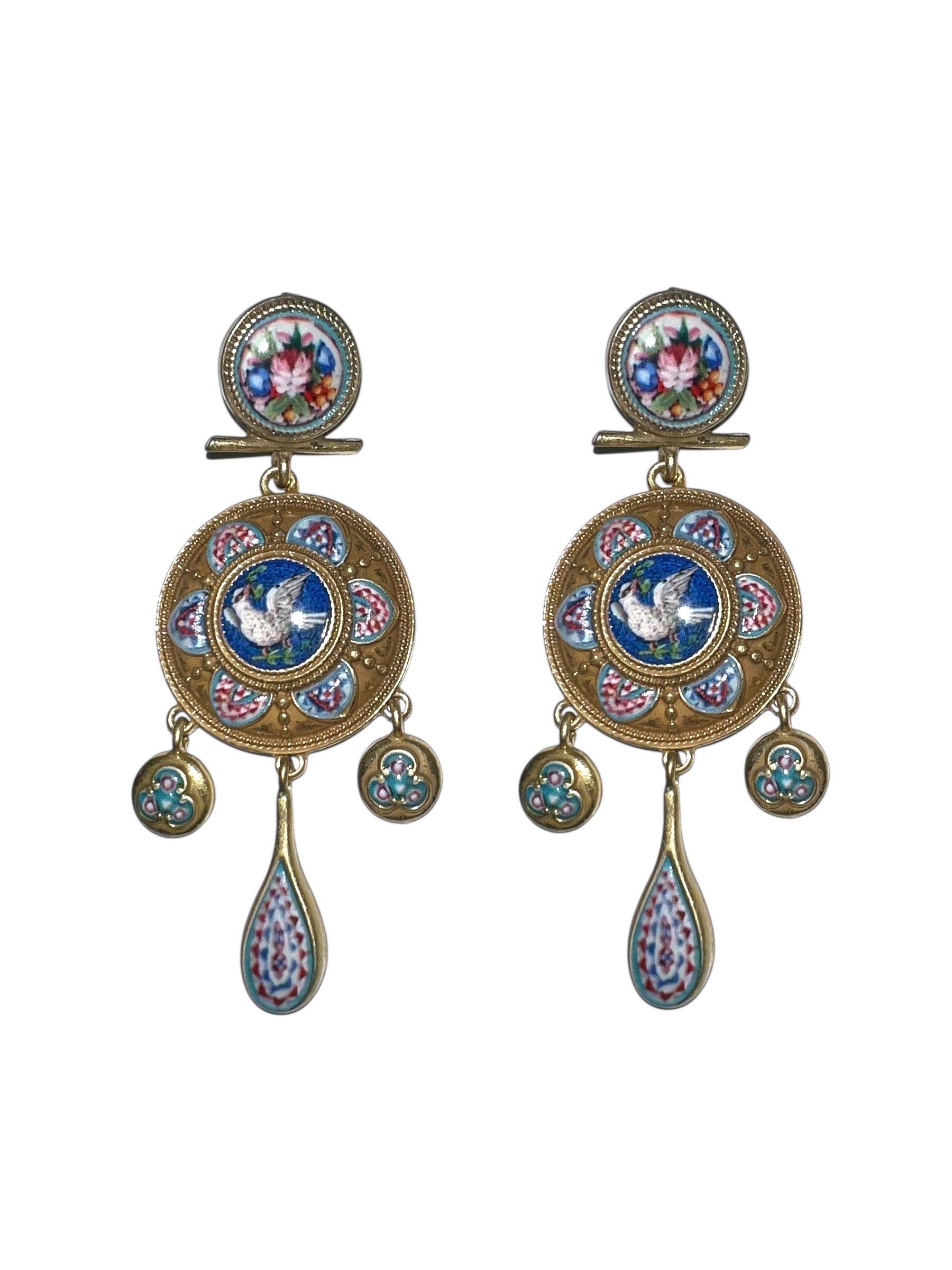 Ornate earrings with floral and bird designs on a white background