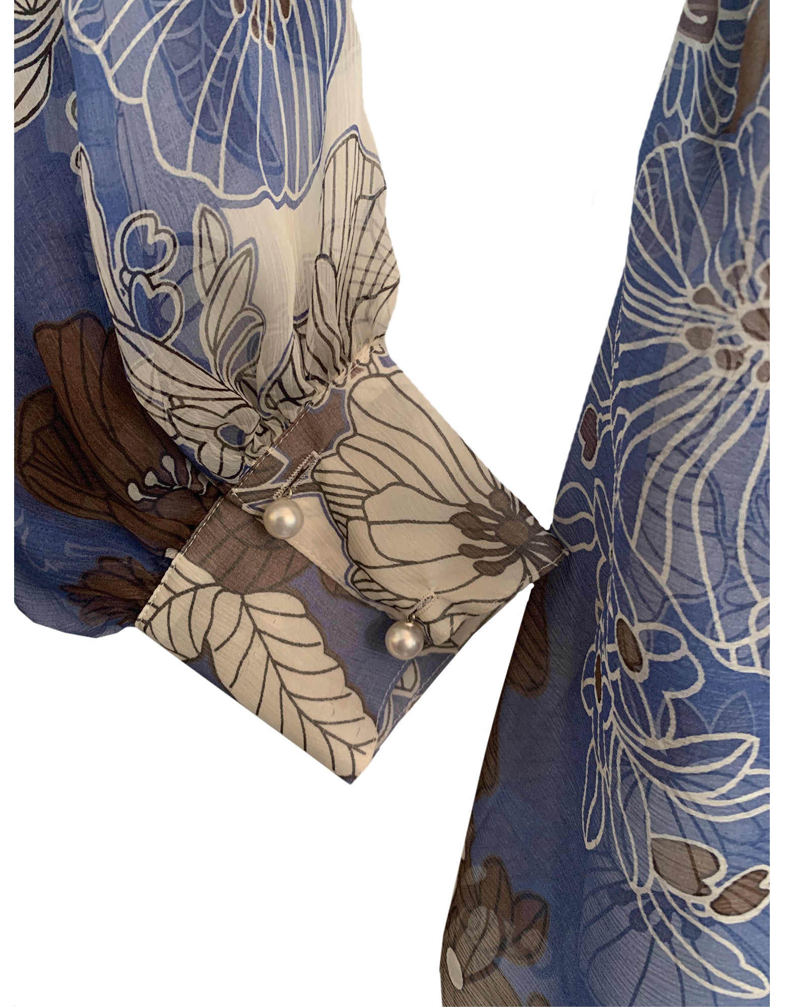 cuff detail of blue floral wrap dress to show pearl buttons