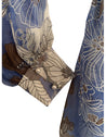 cuff detail of blue floral wrap dress to show pearl buttons