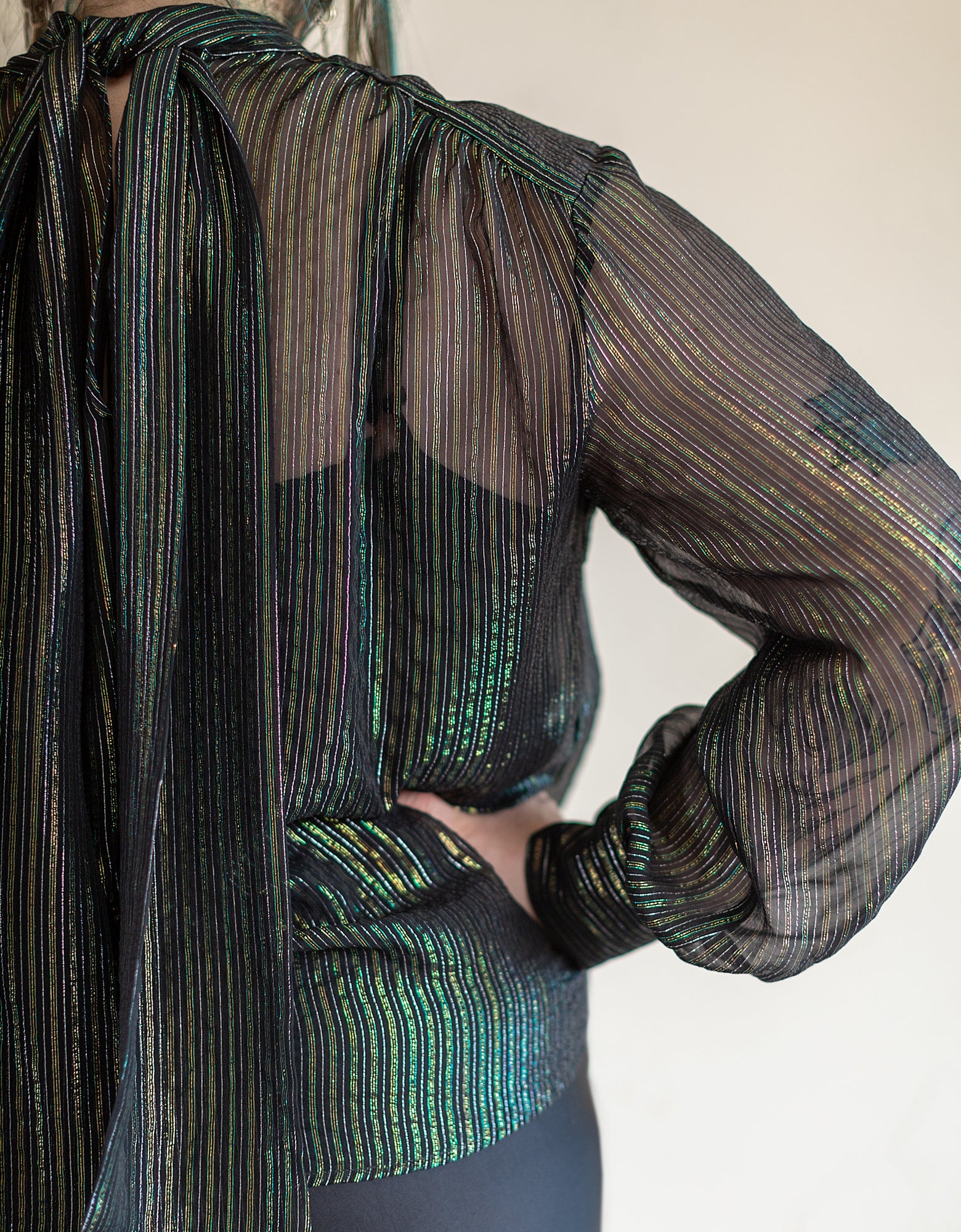 model wearing metallic necktie blouse