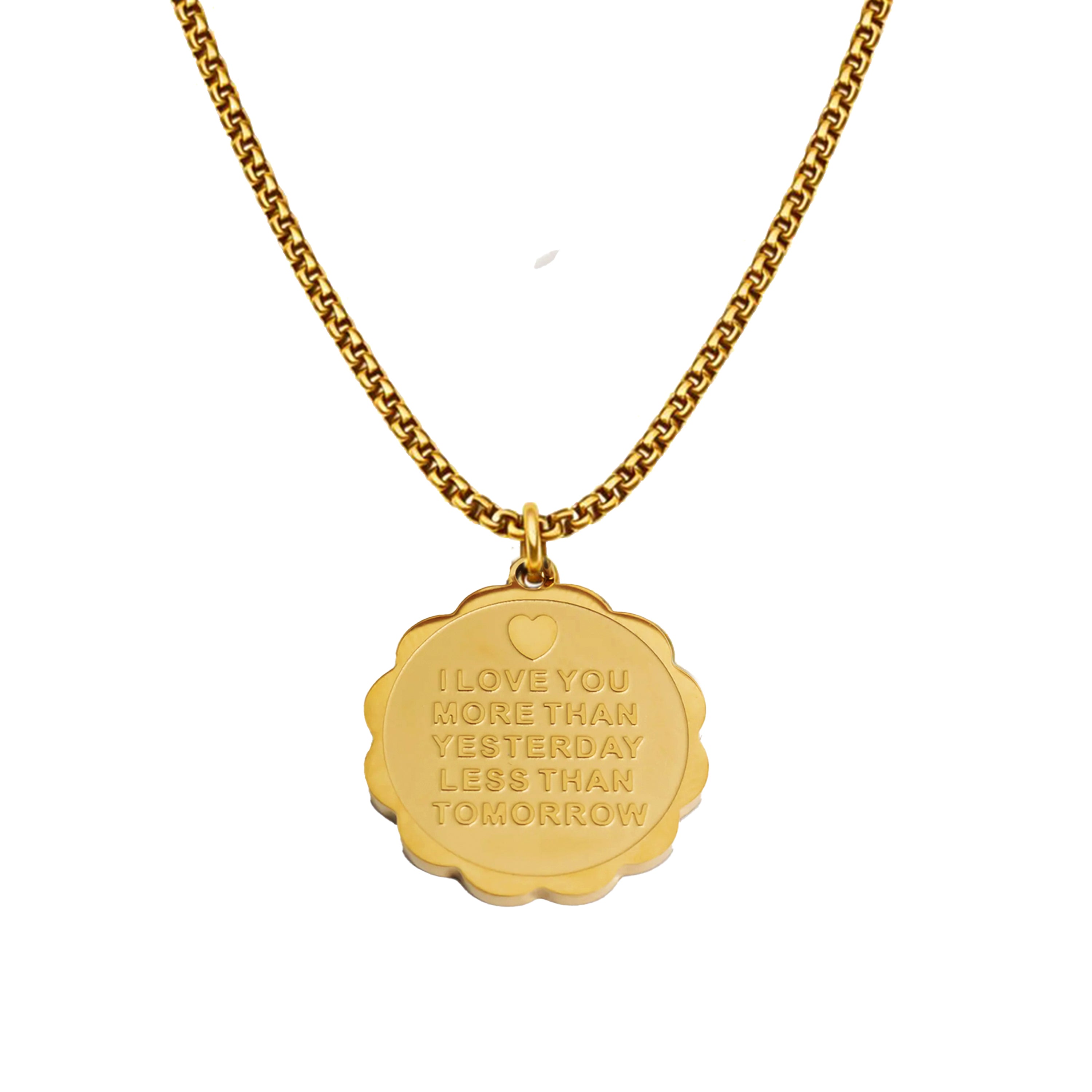 Gold necklace with a pendant engraved with a quote on a white background