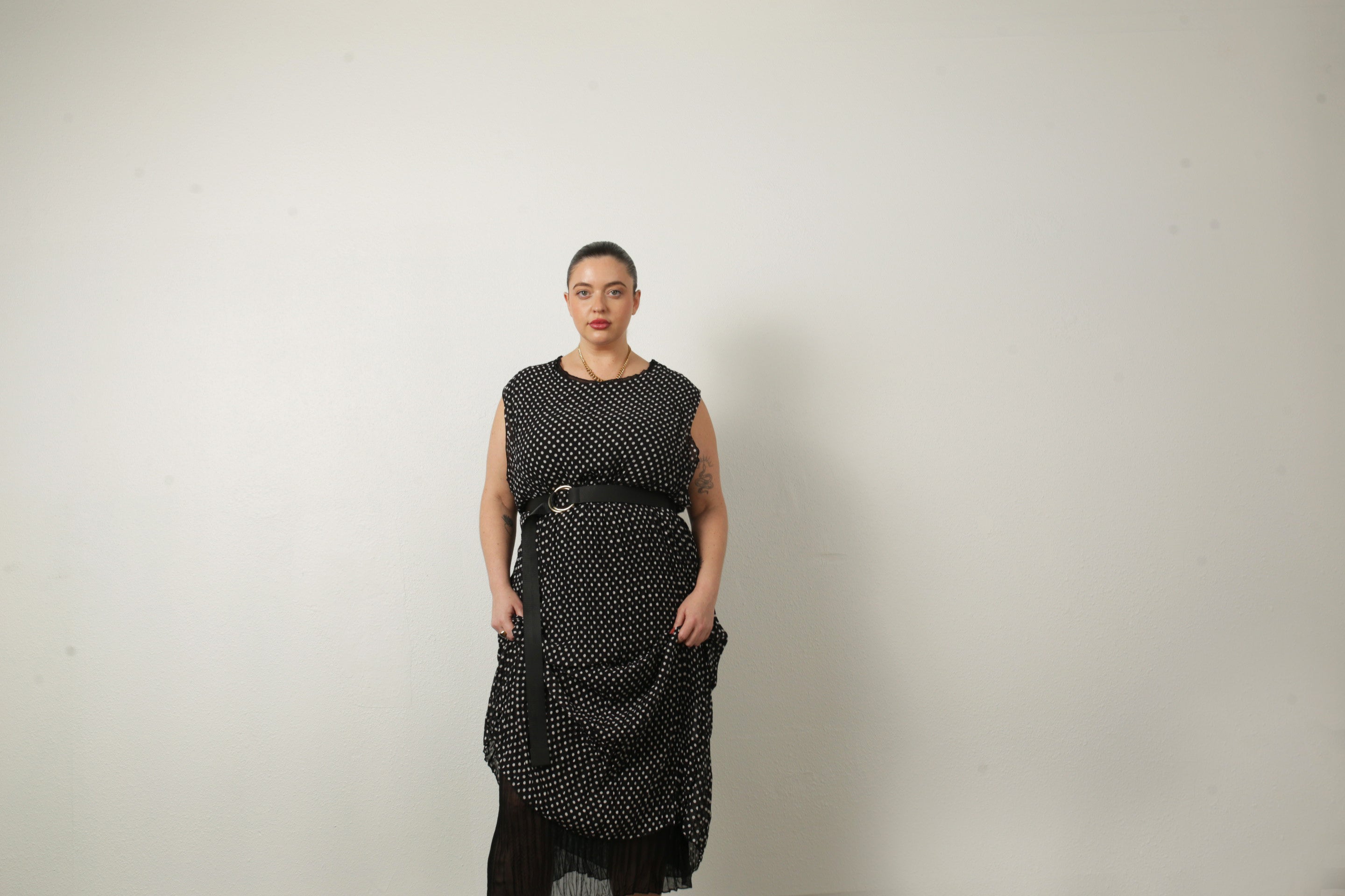 model wearing polka dot jaya with a belt