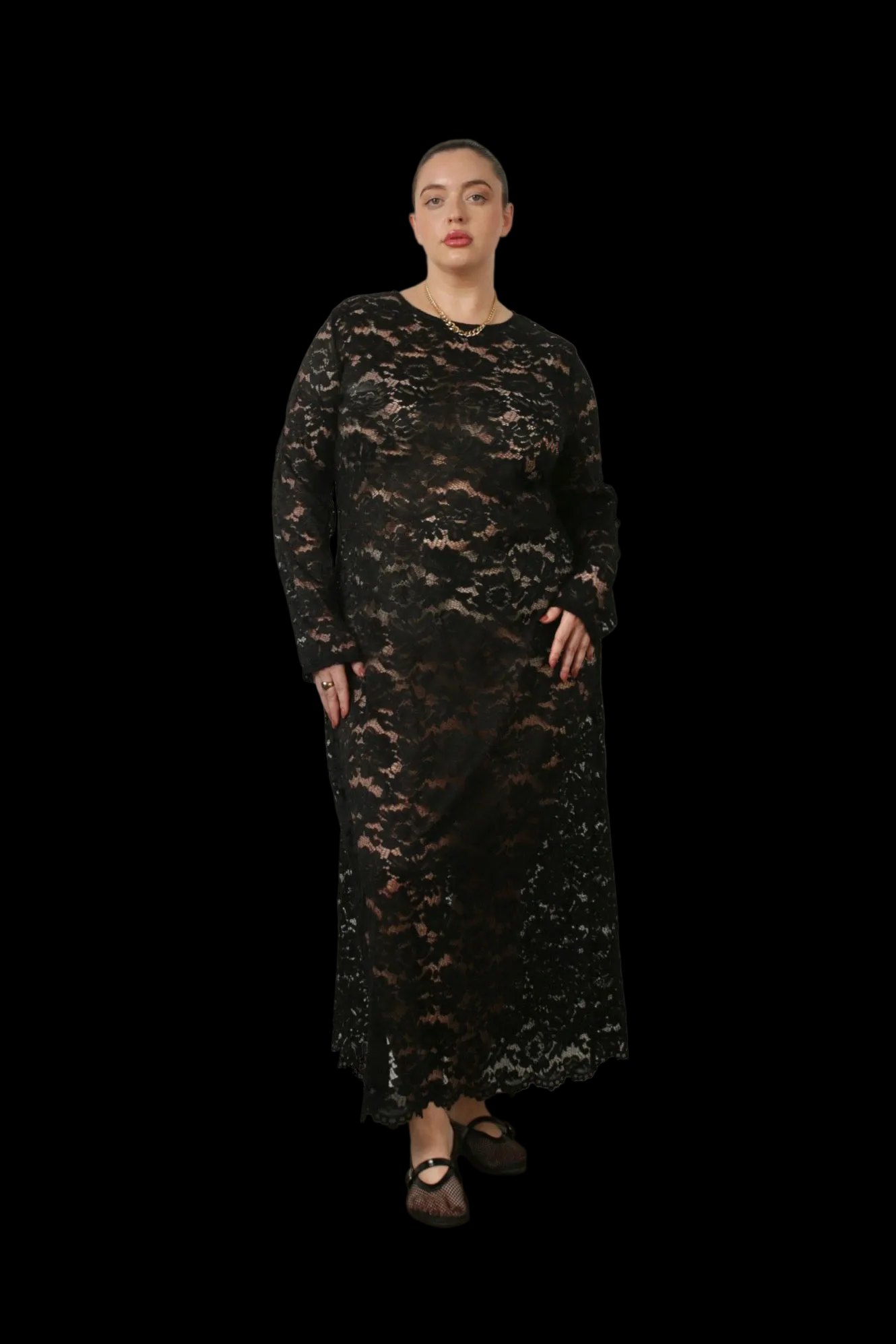 Woman wearing a black lace dress against a black background