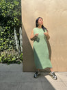 model wearing green pleated dress