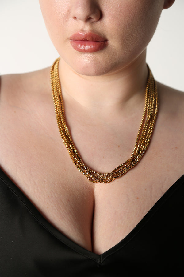 BAACAL - "Thin Boy Slim" is our thin chain. The Rolo Link on this chain gives the appearance of a deeper more matte gold finish. Wear it alone or add charms or a pendant. Perfect for almost any occasion. Layer it or wear it alone for the finishing touch to your everyday outfits. Shown on model wearing multiple pieces.
