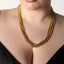 BAACAL - "Thin Boy Slim" is our thin chain. The Rolo Link on this chain gives the appearance of a deeper more matte gold finish. Wear it alone or add charms or a pendant. Perfect for almost any occasion. Layer it or wear it alone for the finishing touch to your everyday outfits. Shown on model wearing multiple pieces.