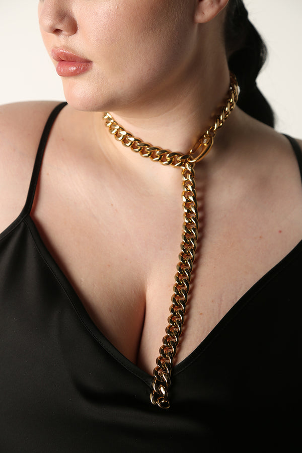 Image on Model - Our Cuban Gold Chain Link can be worn in so many ways. It is adjustable any length up to 24.5".  With its lobster claw clasp, you can wear it as a choker, full length, or double up as a bracelet. If you buy one piece of jewelry this season - this is the one.   A timeless, statement piece with a deep gold shine. Perfect for almost any occasion or your everyday finishing touch to your outfits.
