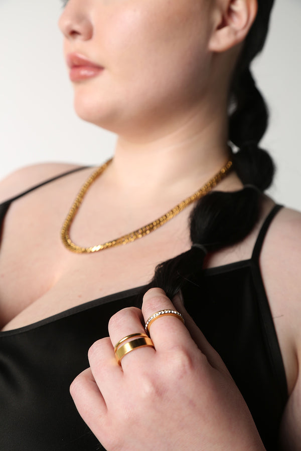 BAACAL - shown on model with other jewelry - The Flat Band ring.  This one, in the same shiny gold finish.  Modern line with a beautiful weight to it.  Perfect to wear alone or stacked.   A stylish option for almost any occasion or your finishing touch to wear every day. 