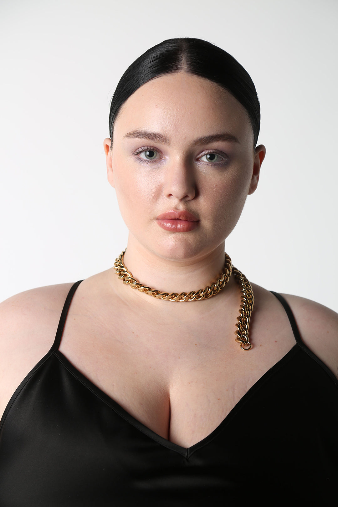 Image on Model - Our Cuban Gold Chain Link can be worn in so many ways. It is adjustable any length up to 24.5".  With its lobster claw clasp, you can wear it as a choker, full length, or double up as a bracelet. If you buy one piece of jewelry this season - this is the one.   A timeless, statement piece with a deep gold shine. Perfect for almost any occasion or your everyday finishing touch to your outfits.